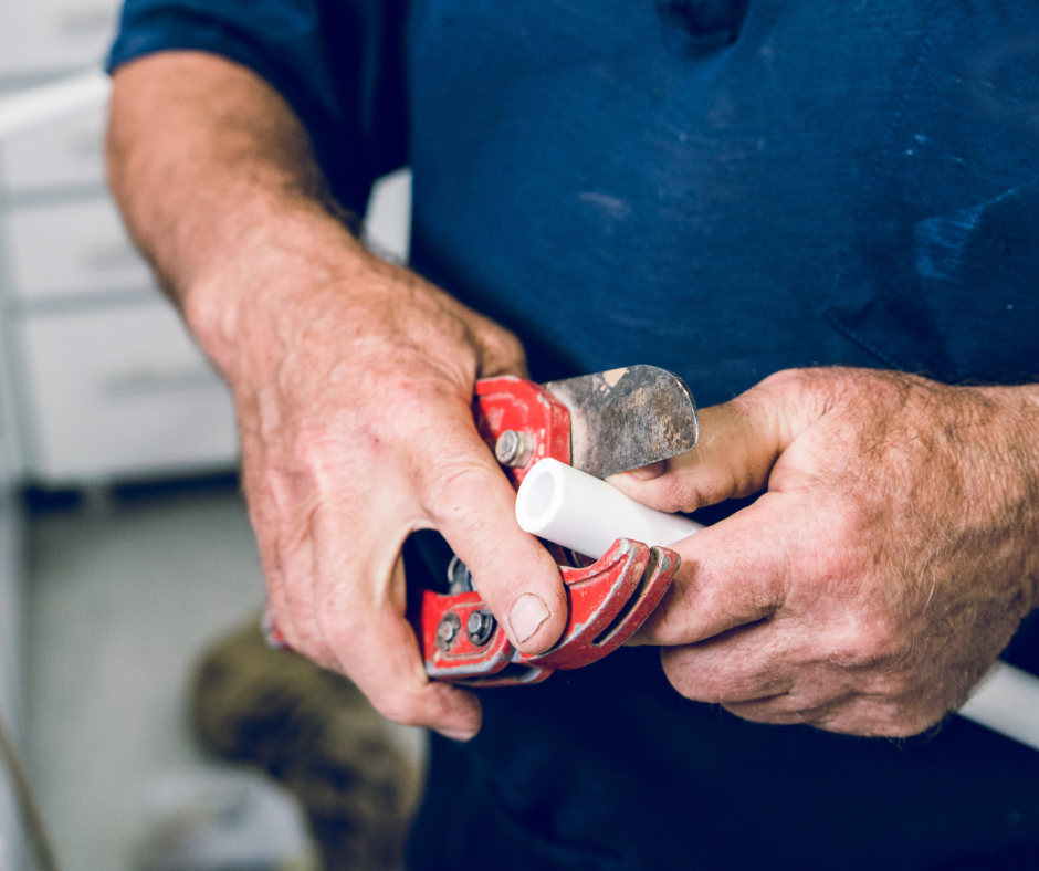 Close-up of hands repairing a water pipe fitting